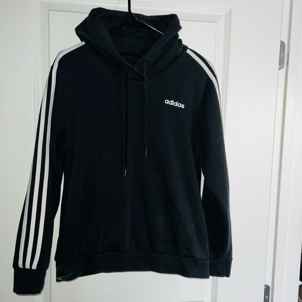 Woman’s Black Adidas hoodie with 3 white stripes along the arms